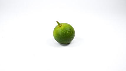 Group of calamansi golden lime heaped and scattered on white background