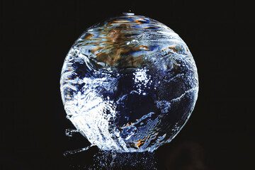 a glass ball over which water flows