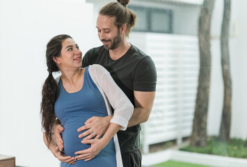 Handsome beard man take care his pregnant wife. Happy family concept.