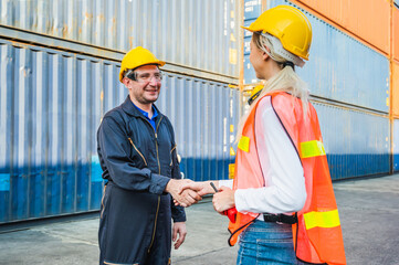 Happy dealing shaking hands two foreman man & woman worker working checking at Container cargo...