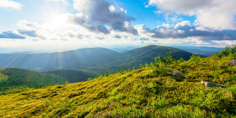 wonderful alpine landscape on summer evening. rolling hills of great mountain range in warm light...