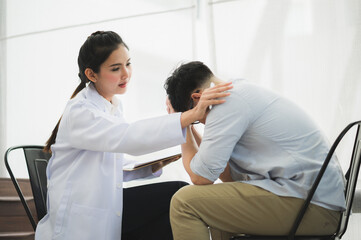 Fototapeta premium Young beautiful asian woman psychologist doctor consulting to male patients lay down on sofa in therapy session.