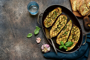 Grilled spicy eggplant in a skillet pan. Top view with copy space.