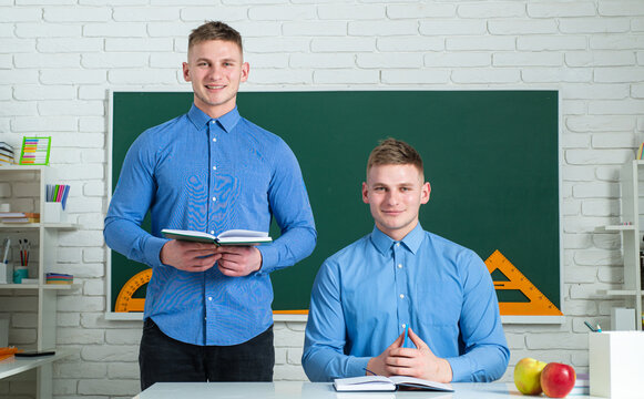 Two Teenage Boys Twins In School Dress With Books. Brother Support. Twin Boys In Uniform On Lesson. Brothers In College Or University.