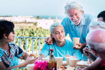 Happy caucasian family celebrate together with different ages people from young teenager to old senior grandfathers in friendship - concept of happyiness and party tradition at home