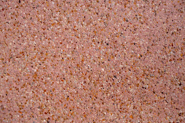 decorative wall with small stones in pink cement