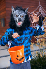 Portrait Of Boy Wearing Fancy Dress Outside House Collecting Candy For Trick Or Treat