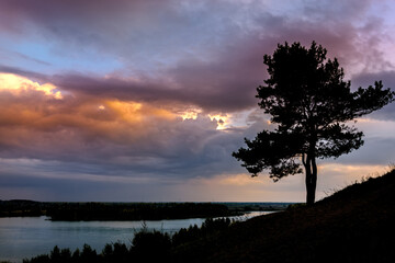 Evening landscape over the river, sky with clouds, sunset