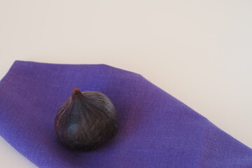Exotic fruit. Purple figs whole, close-up on a white