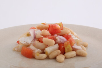 fresh summer salad with beans, cod, tomato and onions