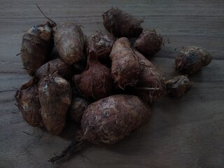 root vegetable taro (Colocasia esculenta) on wooden table