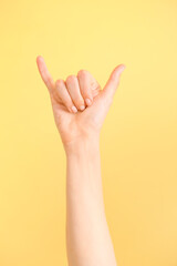Hand showing letter Y on color background. Sign language alphabet