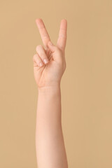 Hand showing letter K on color background. Sign language alphabet