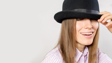 Portrait of a beautiful woman in a felt hat. Laughing girl