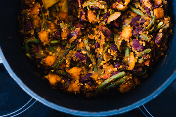 plant-based food, vegan mixed vegetables and red kidney beans getting sauteed in pan on stove