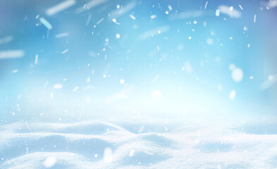 Winter snow background with snowdrifts, beautiful light and falling flakes of snow on blue sky,...