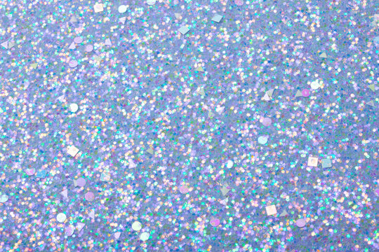 Holographic bright light blue glitter real texture background. © Soleness Moon