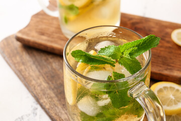 Cup of tasty cold ice tea on table, closeup