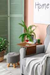 Armrest table on armchair in interior of room