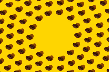 Creative bright collage of real macro photos of selected coffee beans on a yellow background with a hard shadow in the shape of a heart with a place for inscription.