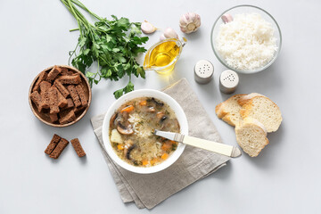 Bowl of tasty rice soup on table
