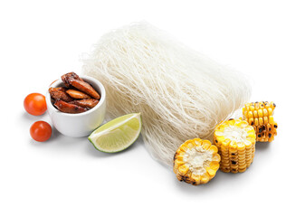 Raw rice noodles with ingredients on white background
