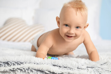 Cute little baby on bed at home