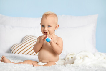 Cute little baby on bed at home