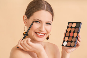 Young woman with beautiful eyeshadows on color background - obrazy, fototapety, plakaty