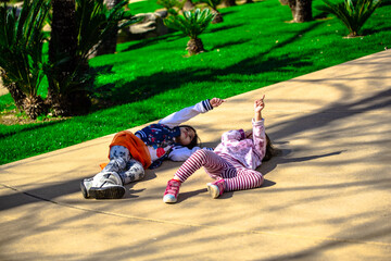 tow little girls having fun on the park looking at the sky