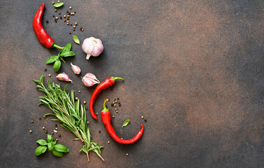 Set of spices, garlic, fresh basil and chili on a concrete background. View from above.