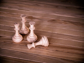 handmade wooden chess pieces on wooden board