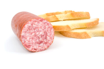 smoked sausage and several slices of white bread isolated on white background.