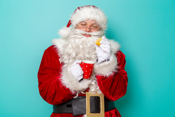 Santa Claus adding lemon into tea cup