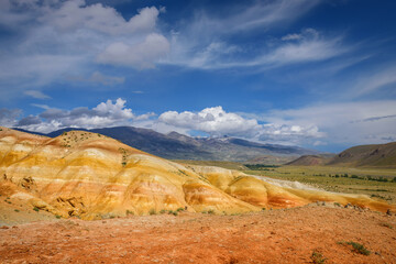 Amazing natural phenomenon-Martian landscapes in the Altai mountains. Multicolored rocks against a blue sky with white clouds. Futuristic panoramic picture, background image. Mars.