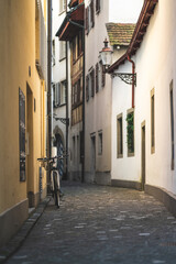 A narrow alley in the old town with a parked bike