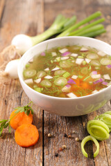vegetable and broth on wood background