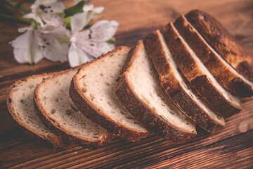 on the wooden table are slices of sliced white bread
