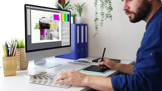 Graphic designer working with computer and graphic tablet