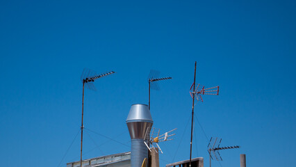 Aerial antennas, blue sky background, telecommunication equipment, 5G, old school technology, outdoor wiretapping