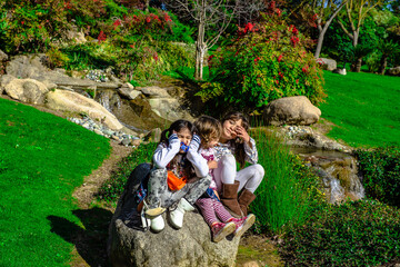 family together on the park 3 pretty girls 