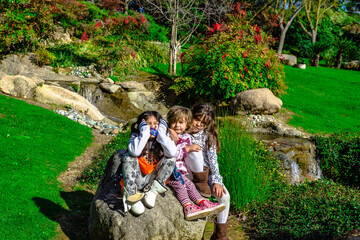 family together on the park 3 pretty girls 