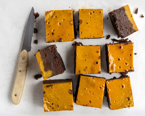 Pumpkin chocolate brownie. Thanksgiving day food. White stone background.