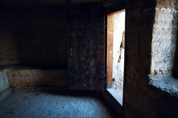 Empty stone room and open ancient door 