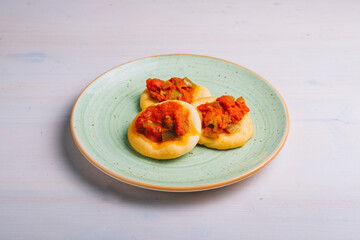 Freshly baked mini pizza сoca with tomatoes and vegetables . Traditional Spanish pastry with...