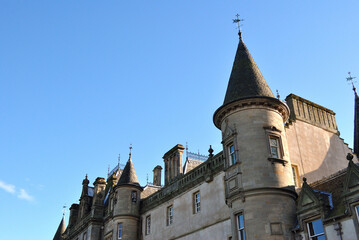 French Style Scottish Baronial Building-Angled View from Below against Blue sky 