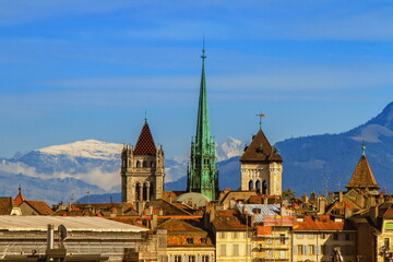 Cathedral Saint-Pierre towers and Alps mountains by day, Geneva, Switzerland