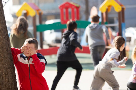 Teenage playing hide-and-go-seek in the playground. High quality photo