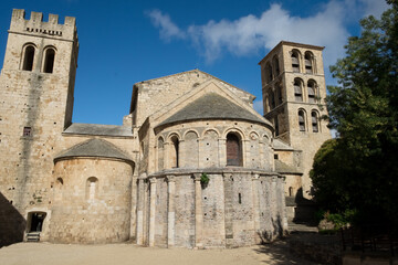 The ancient stone architecture and the blooming garden of the old  catholic Caunes Minervois abbey located in the most beautiful medieval village of France