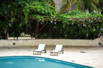 Swimming Pool at tropical beach - summer vacation background.